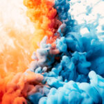 orange and blue ink colliding