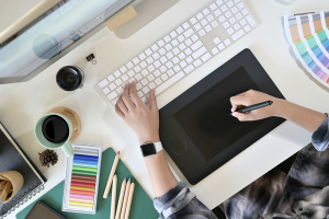 Women designing a logo on a tablet