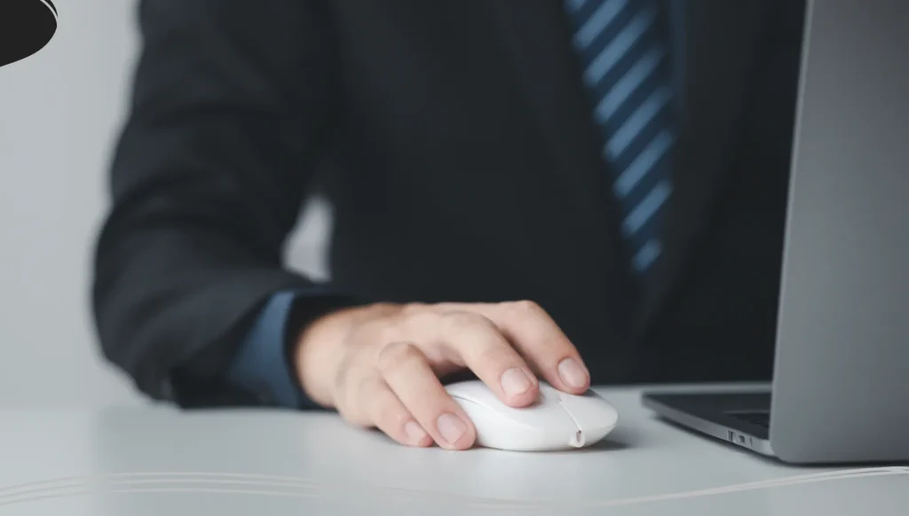 Person typing on laptop keyboard, businessman working on laptop, he is typing messages to colleagues.