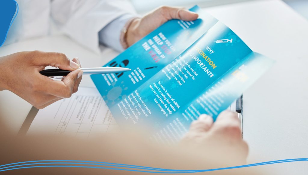 Person pointing to a tri-fold brochure