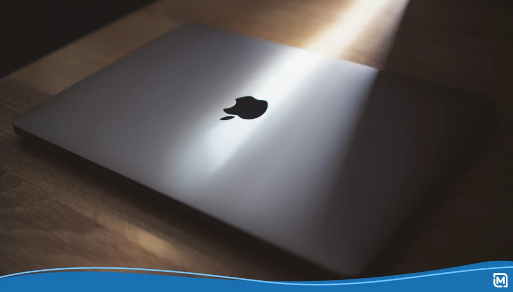 An image of an Apple laptop showing the company's distinctive modern logo design