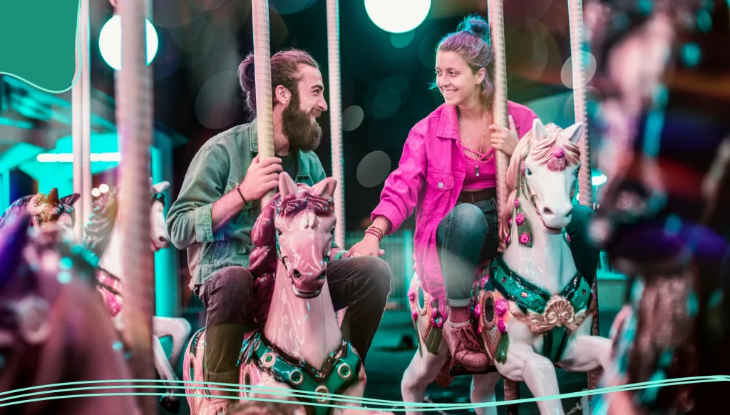 A couple ride on a fairground carousel