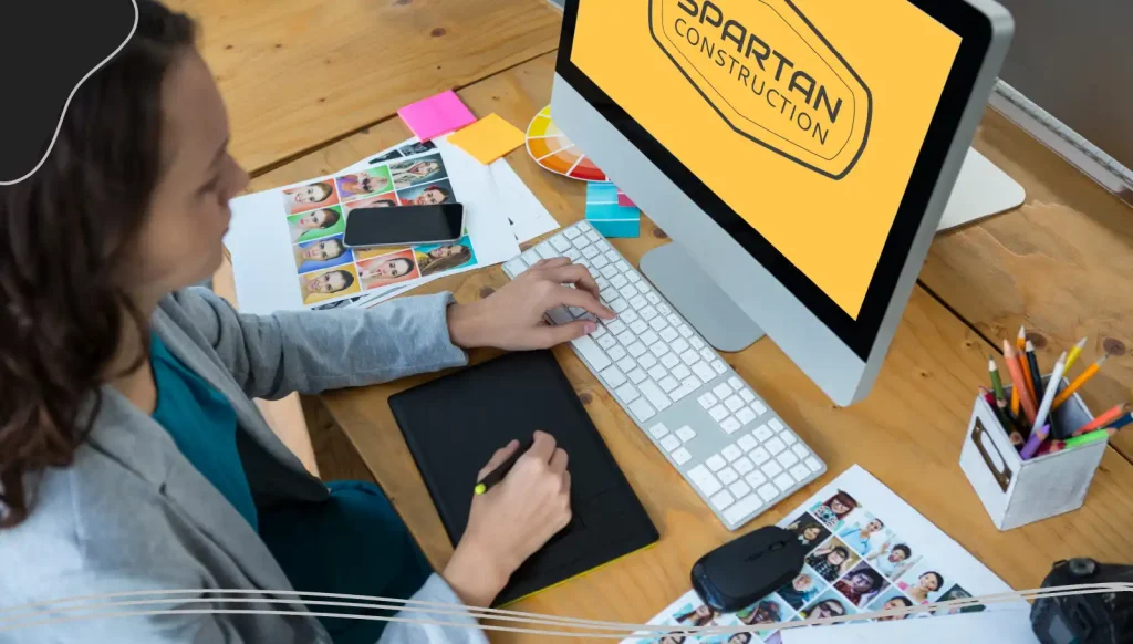 Woman working on a logo design on her computer for a construction company