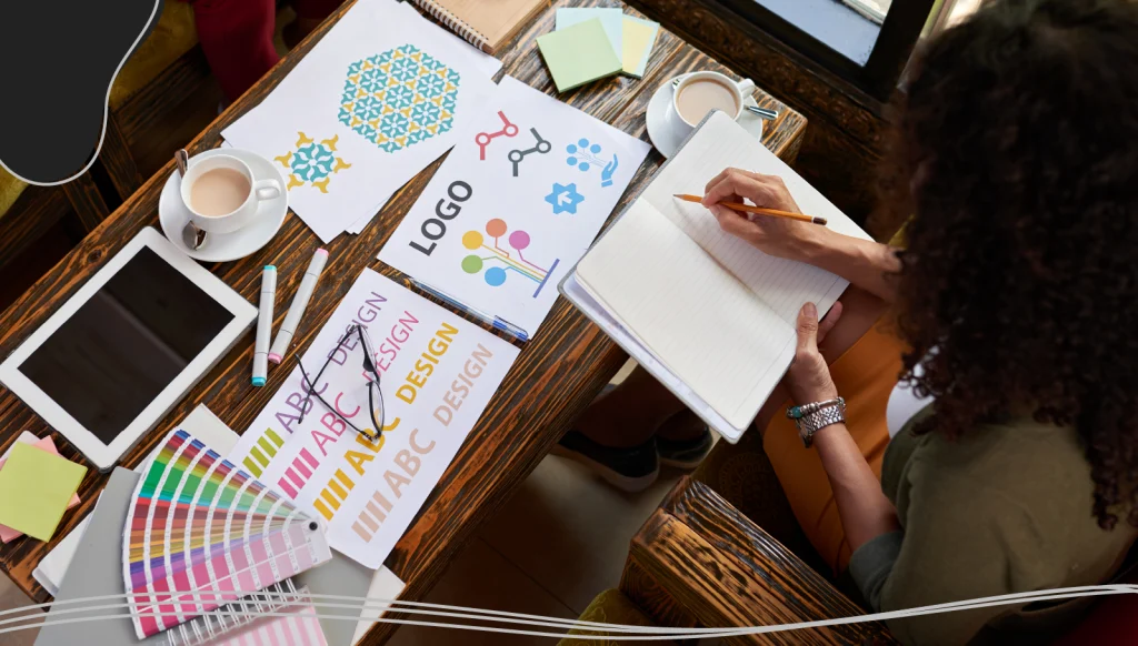 Two people brainstorming a graphic for a business card