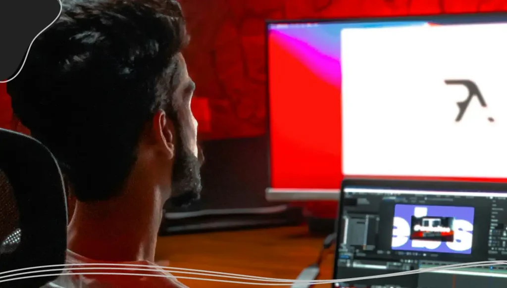 Man looking at a computer screen designing a business card