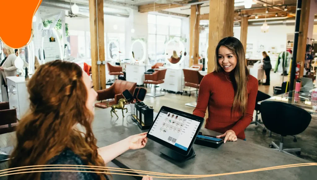 Person paying using a card in a hair salon.