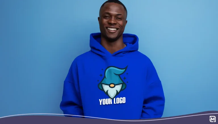 Close-up of an emotional young guy in a blue sweatshirt with a hood on a studio background.