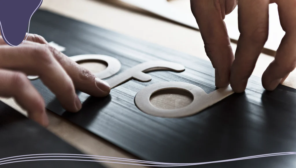 Man placing experimental typography text on a logo design